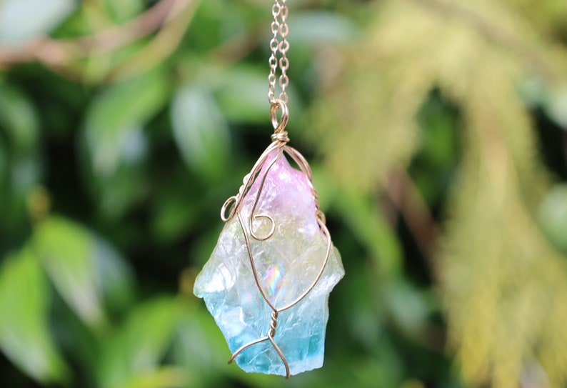 Colorful Quartz Crystal Rainbow Stone Wire Wrapped Crystal Pendant  A Quartz Crystal Rainbow Stone pendant encompasses the natural beauty and energetic properties of quartz crystal