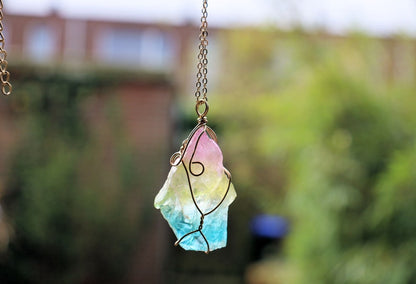 Colorful Quartz Crystal Rainbow Stone Wire Wrapped Crystal Pendant  A Quartz Crystal Rainbow Stone pendant encompasses the natural beauty and energetic properties of quartz crystal