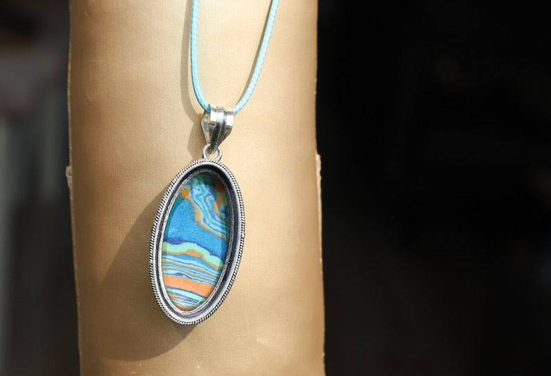Rainbow Calsilica 925 Silver Plated Handmade Pendant. Rainbow calsilica is a colorful and intriguing material often used in jewelry and decorative objects