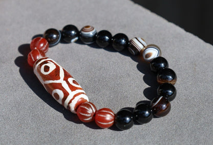 The six-eye dZi bead symbolizes luck and control, promoting health and longevity. With black striped agate 10 mm beads.  physical strength.