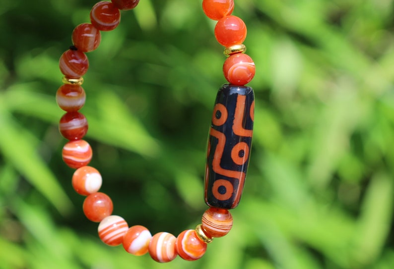 Nine-eye dZi bead with beautiful Orange striped agate beads. The Star of Prosperity and the Heaven Protection