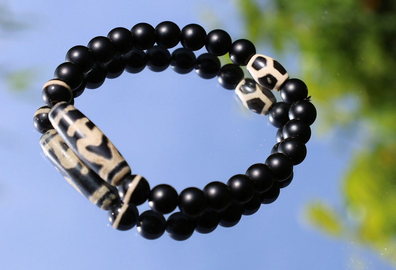 Nectar vesse" Dzi bead with Matte onyx beads and 3 medicine dzi beads. helping to balance the body's energies