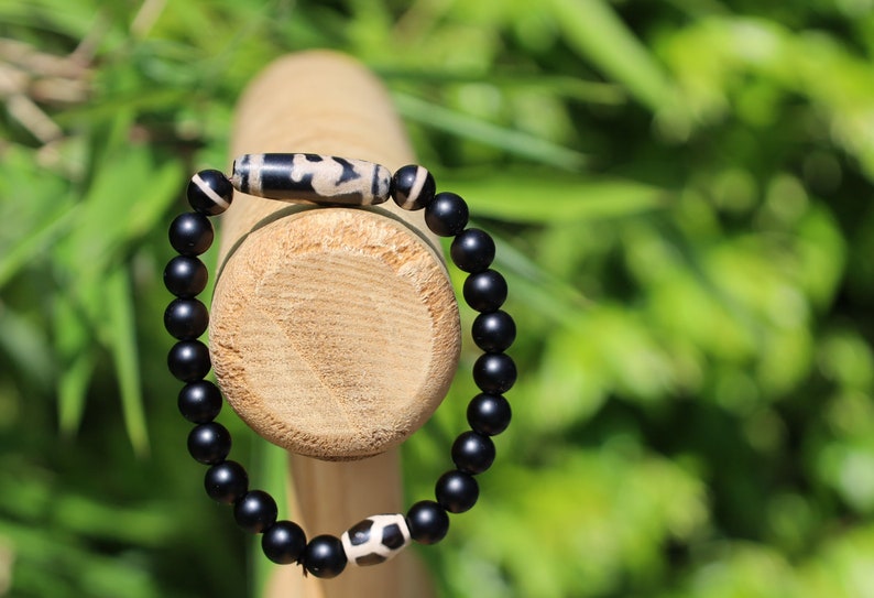 Nectar vesse" Dzi bead with Matte onyx beads and 3 medicine dzi beads. helping to balance the body's energies