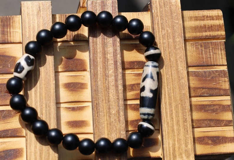 Nectar vesse" Dzi bead with Matte onyx beads and 3 medicine dzi beads. helping to balance the body's energies