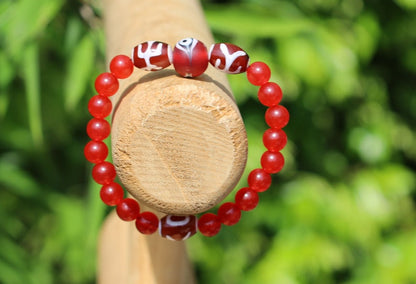 Big man 3x dzi with Carnelian beads and a Evil Eye Glass Bead. The stone helps to solve problems and release stress