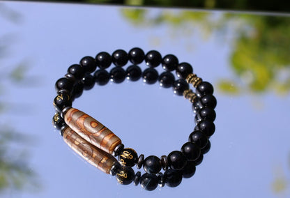 Three-eye dZi bead with black onyx beads and With Agate Om mani padme hum beads. jewel in the lotus.