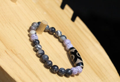Three-eye dZi bead with  Starmoon Bodhi Barrel Beads and Black silk stone beads. This is one of the most powerful beads