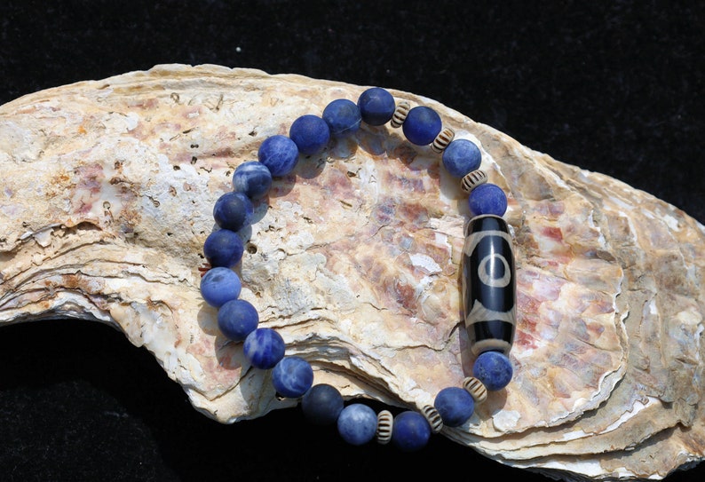 Three-eye dZi bead with   Blue Jasper and 6x Chevron-style tradebeads. connects you to the spiritual world.