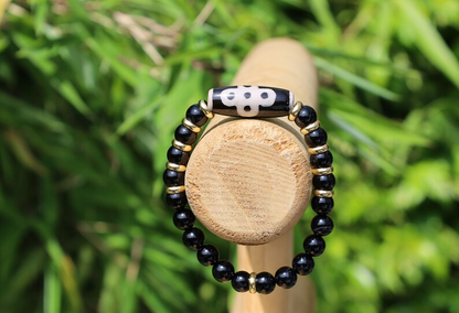 Five eyed lightning Dzi  bead with black onyx beads bracelet and Brass Spacer Beads, Rings, Golden color. Surrounded by myth and mystery