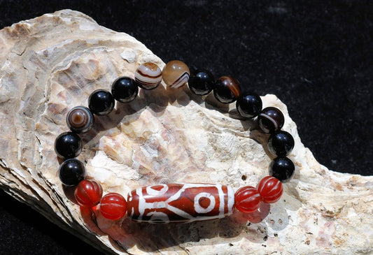The six-eye dZi bead symbolizes luck and control, promoting health and longevity. With black striped agate 10 mm beads.  physical strength.