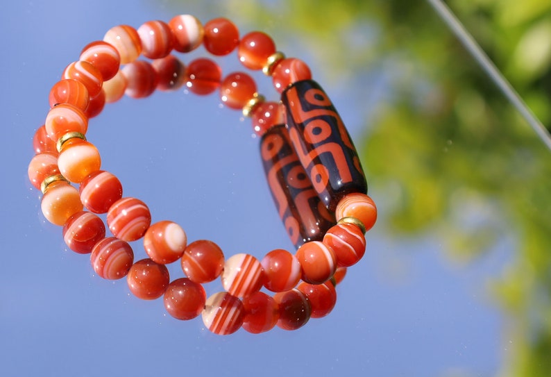 Nine-eye dZi bead with beautiful Orange striped agate beads. The Star of Prosperity and the Heaven Protection