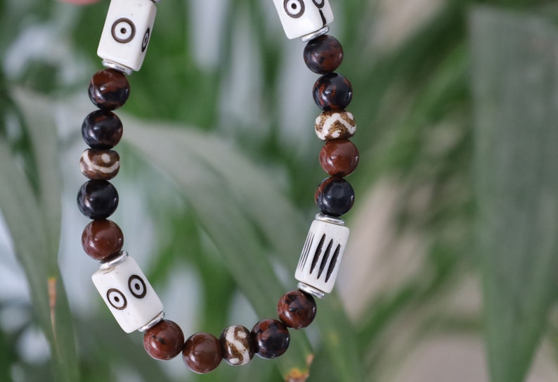 Unique and Artistic  Golden Swan bracelet with white tube bone beads with patterns. WAJAKAA DESIGNS - The art of expressing your taste and style.