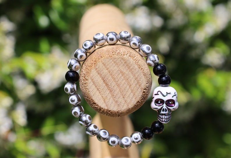 One-of-a-kind  Colorful acrylic skull  and Electroplate Glass beads with  Onyx is associated with grounding energy.