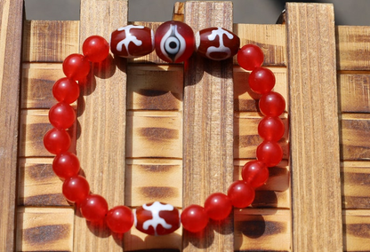 Big man 3x dzi with Carnelian beads and a Evil Eye Glass Bead. The stone helps to solve problems and release stress