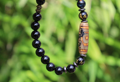 Three-eye dZi bead with black onyx beads and With Agate Om mani padme hum beads. jewel in the lotus.