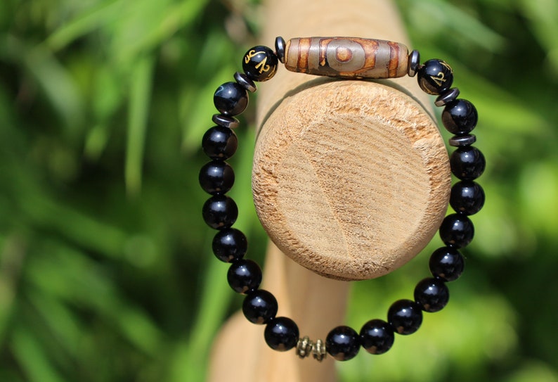 Three-eye dZi bead with black onyx beads and With Agate Om mani padme hum beads. jewel in the lotus.