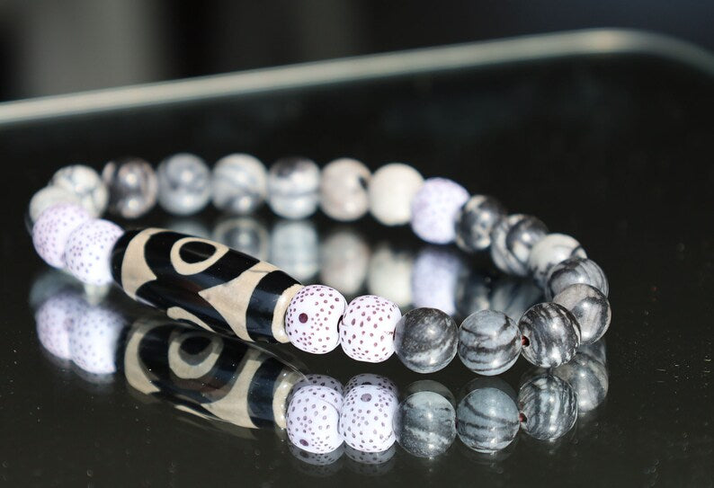 Three-eye dZi bead with  Starmoon Bodhi Barrel Beads and Black silk stone beads. This is one of the most powerful beads