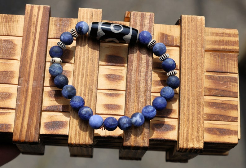 Three-eye dZi bead with   Blue Jasper and 6x Chevron-style tradebeads. connects you to the spiritual world.