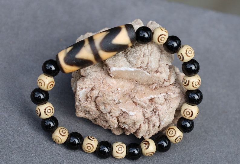Old Double DZI Tiger’s Teeth Bracelet with  Onyx and Spiral beads. Visually striking with profound spiritual significance.