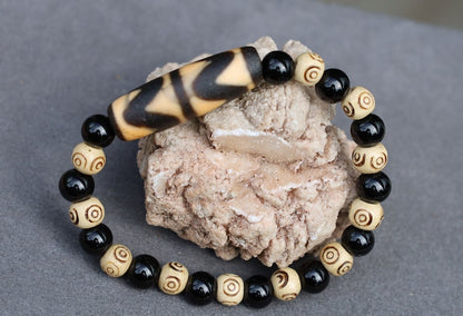 Old Double DZI Tiger’s Teeth Bracelet with  Onyx and Spiral beads. Visually striking with profound spiritual significance.