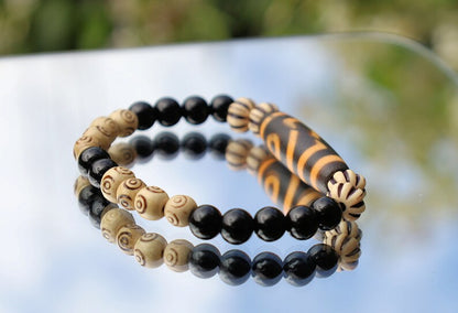 Old Two-eye dZi bead Bracelet with  Onyx and Spiral pattern beads. Visually striking with profound spiritual significance.