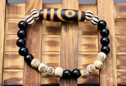 Old Two-eye dZi bead Bracelet with  Onyx and Spiral pattern beads. Visually striking with profound spiritual significance.