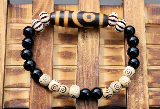 Old Two-eye dZi bead Bracelet with  Onyx and Spiral pattern beads. Visually striking with profound spiritual significance.