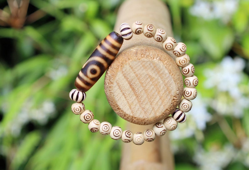 Old Two-eye dZi bead Bracelet with  and Spiral pattern beads. Visually striking with profound spiritual significance.