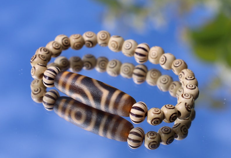 Old Two-eye dZi bead Bracelet with  and Spiral pattern beads. Visually striking with profound spiritual significance.