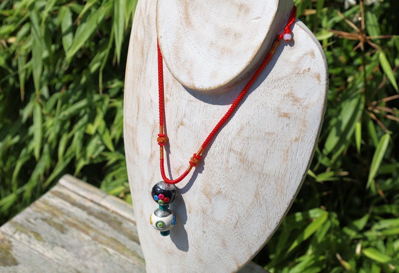 Introducing our exquisite Double Handmade Tibetan Style Round Beads Necklace, featuring a unique blend of craftsmanship and tradition