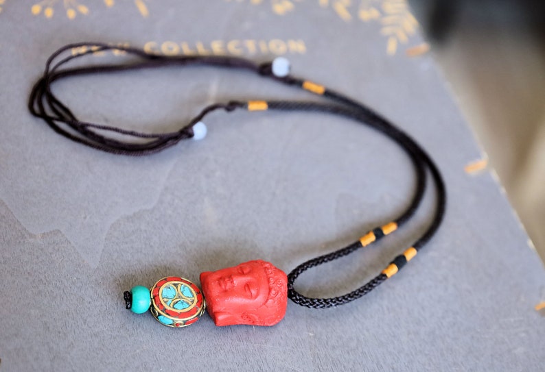 A beautiful large, handcrafted bead of real red Cinnabar Buddha with prayerbead from Nepal and Tibetan turquoise buddhist prayer bead