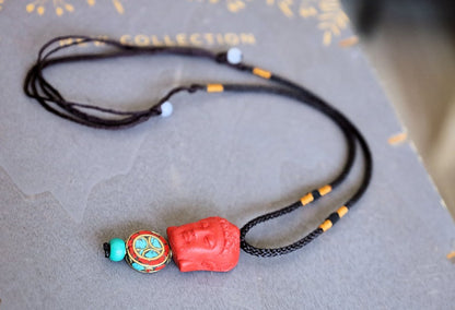 A beautiful large, handcrafted bead of real red Cinnabar Buddha with prayerbead from Nepal and Tibetan turquoise buddhist prayer bead