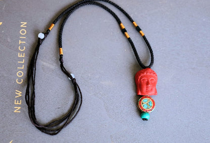 A beautiful large, handcrafted bead of real red Cinnabar Buddha with prayerbead from Nepal and Tibetan turquoise buddhist prayer bead