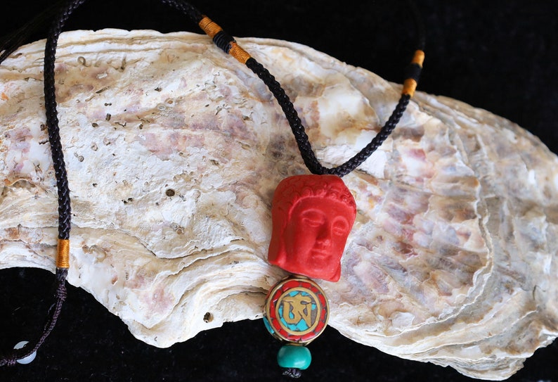 A beautiful large, handcrafted bead of real red Cinnabar Buddha with prayerbead from Nepal and Tibetan turquoise buddhist prayer bead