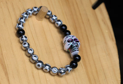 One-of-a-kind  Colorful acrylic skull  and Electroplate Glass beads with  Onyx is associated with grounding energy.