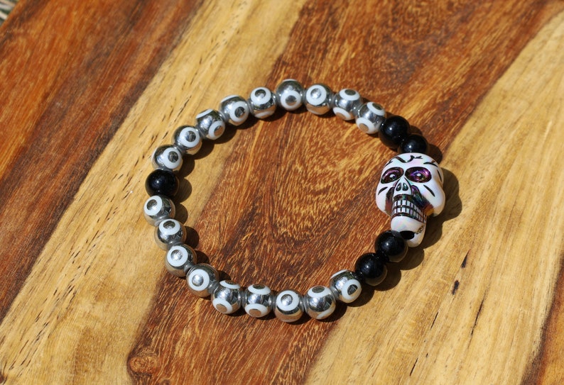 One-of-a-kind  Colorful acrylic skull  and Electroplate Glass beads with  Onyx is associated with grounding energy.