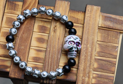 One-of-a-kind  Colorful acrylic skull  and Electroplate Glass beads with  Onyx is associated with grounding energy.