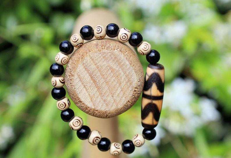 Old Double DZI Tiger’s Teeth Bracelet with  Onyx and Spiral beads. Visually striking with profound spiritual significance.