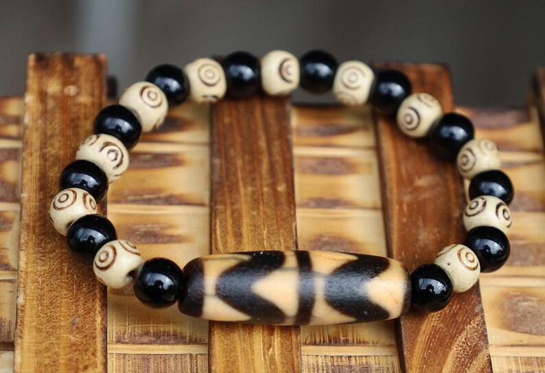 Old Double DZI Tiger’s Teeth Bracelet with  Onyx and Spiral beads. Visually striking with profound spiritual significance.