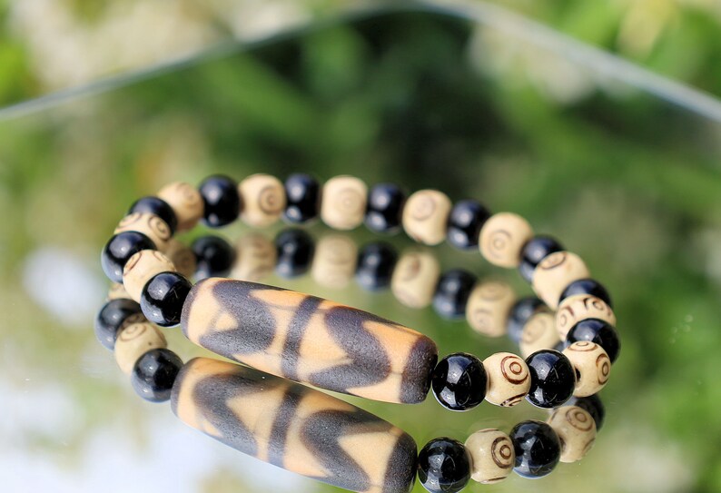 Old Double DZI Tiger’s Teeth Bracelet with  Onyx and Spiral beads. Visually striking with profound spiritual significance.