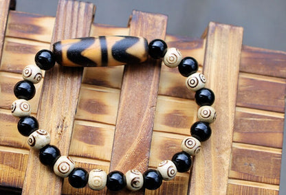 Old Double DZI Tiger’s Teeth Bracelet with  Onyx and Spiral beads. Visually striking with profound spiritual significance.