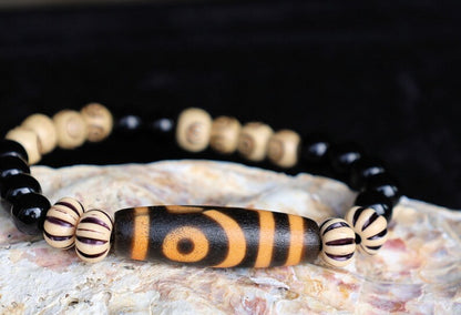 Old Two-eye dZi bead Bracelet with  Onyx and Spiral pattern beads. Visually striking with profound spiritual significance.
