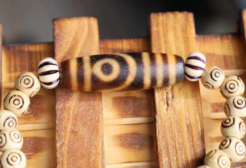Old Two-eye dZi bead Bracelet with  and Spiral pattern beads. Visually striking with profound spiritual significance.