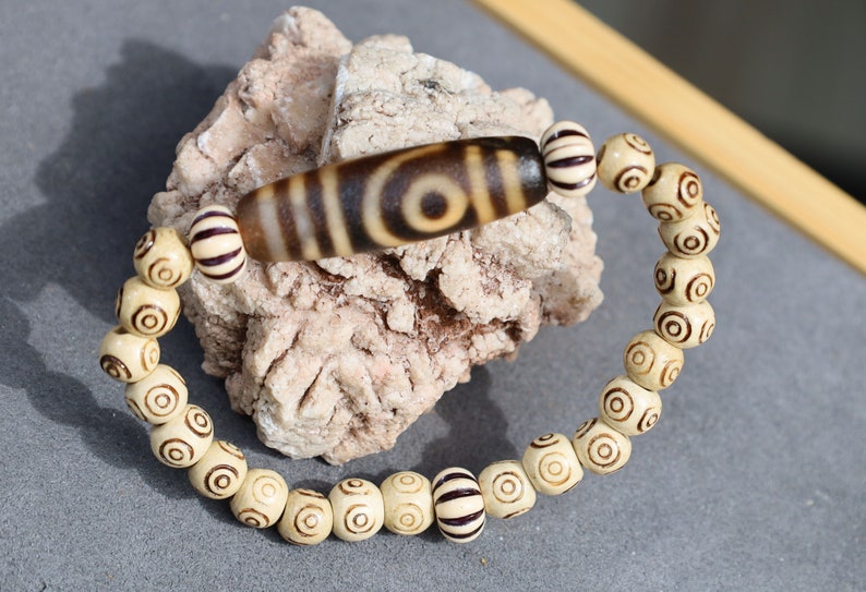 Old Two-eye dZi bead Bracelet with  and Spiral pattern beads. Visually striking with profound spiritual significance.