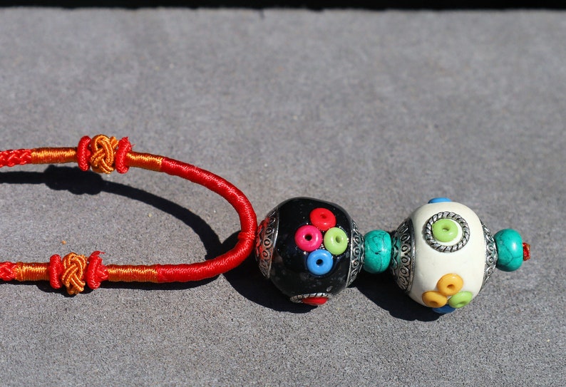 Introducing our exquisite Double Handmade Tibetan Style Round Beads Necklace, featuring a unique blend of craftsmanship and tradition