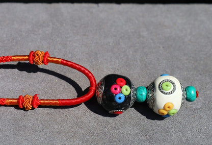 Introducing our exquisite Double Handmade Tibetan Style Round Beads Necklace, featuring a unique blend of craftsmanship and tradition