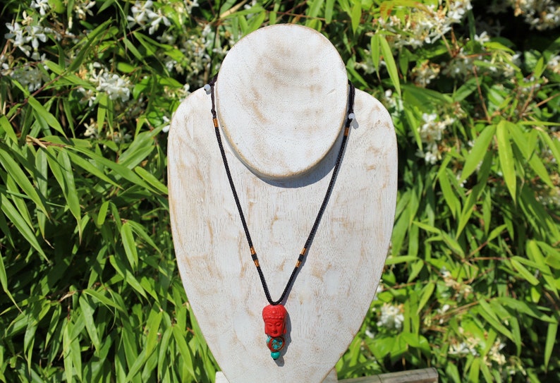 A beautiful large, handcrafted bead of real red Cinnabar Buddha with prayerbead from Nepal and Tibetan turquoise buddhist prayer bead