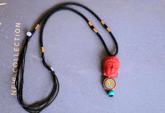 A beautiful large, handcrafted bead of real red Cinnabar Buddha with prayerbead from Nepal and Tibetan turquoise buddhist prayer bead