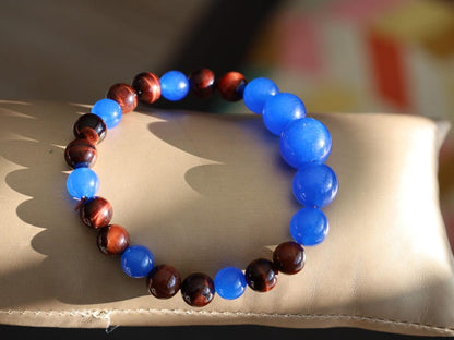 A bracelet made with Royal Blue Jade and Red Tiger Eye beads is a striking combination that blends elegance and vibrant energy.