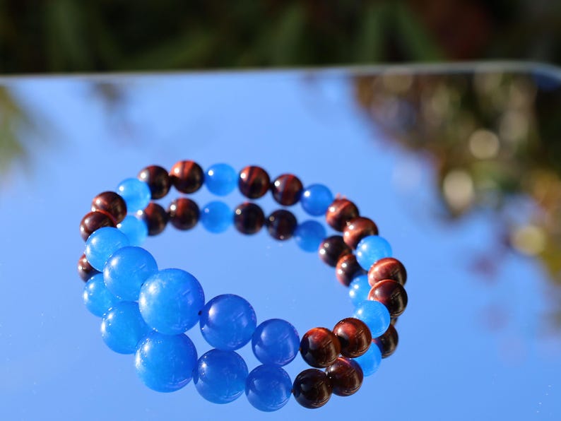 A bracelet made with Royal Blue Jade and Red Tiger Eye beads is a striking combination that blends elegance and vibrant energy.